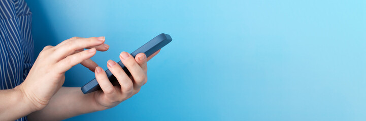 hands holding a phone on a blue background, modern smartphone, mobile applications,online...