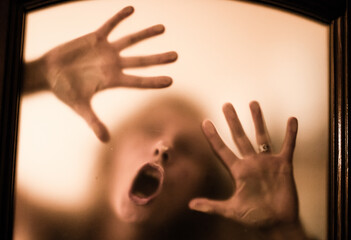 scary picture of hands behind glass, horror ghost woman behind door, Halloween  concept