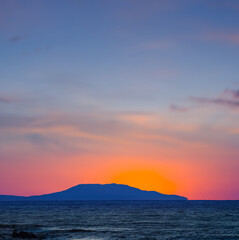sea cape silhouette at the sunrise, early morning sea scene