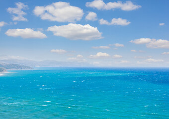 emerald sea under blue cloudy sky