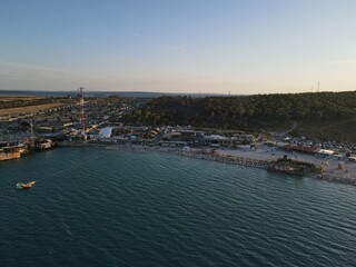Obraz premium Aerial view of Zrce Beach Festival in Novalja, island Pag, archipelago of Croatia. People partying on a hot summer day on Zrce beach. Zrce beach is the most popular party destination on Adriatic sea.