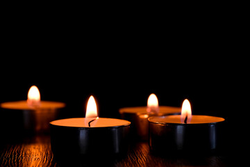 Candle light and bokeh background in the darkness with space for text or image.