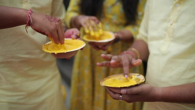 A Slow Motion Shot of People Mixing Haldi at an Indian Wedding in India