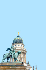 Fototapeta na wymiar Cover page with statue of panther with genius of music, angel with wings and harp, stringed musical instrument at Concert Hall at French Church in Berlin, Germany with blue sky background copy space.