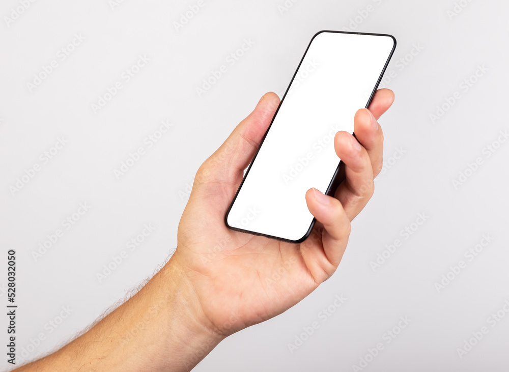 Poster Hand holding phone mockup in angled position. template with empty screen. Using smartphone in daily life.