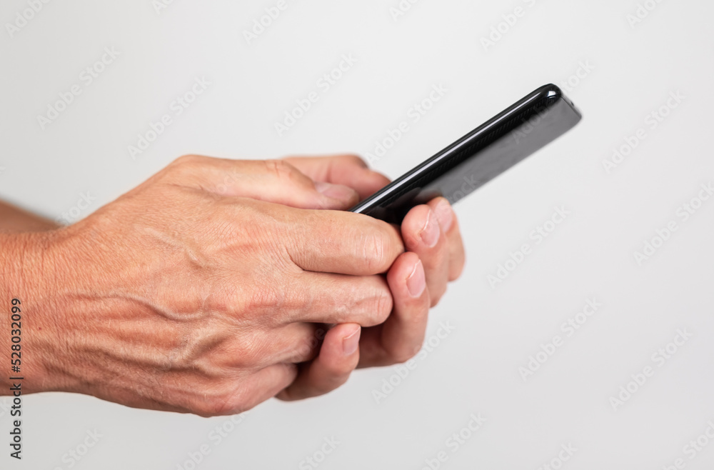 Poster Man hands closeup texting message at phone. Male using messenger or searching information on Internet.