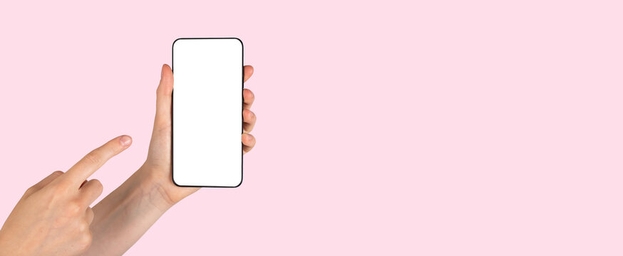 Banner with forefinger pointing to phone mockup on pink background. Smartphone template with blank screen. Woman showing information in telephone. Space for text