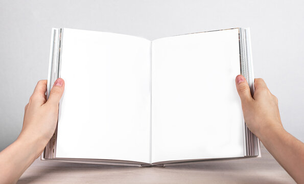 Hands holding open book mockup with white blank pages. Woman reading literature. Intellectual development, education, information learning concept