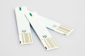 Glucometer test strips on a white background