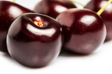 Fresh black sweet cherry fruit on white background.