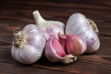 Garlic cloves on wooden table. Fresh peeled garlics and bulbs.