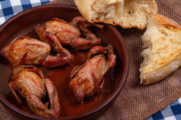 Rustic dinner. Roasted quail meat and white bread