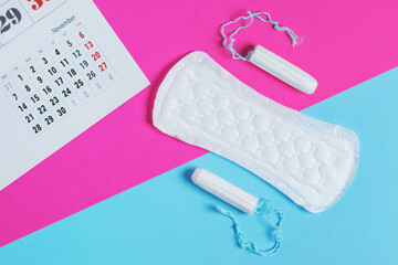 Woman hygiene protection, menstruation calendar and clean cotton tampons and gasket pad.