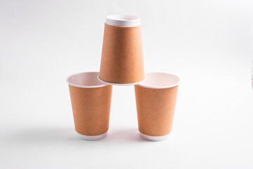 A disposable coffee cup without a lid isolated on a white background