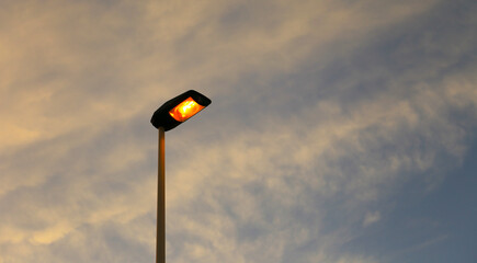 High lamppost in the afternoon at sunset