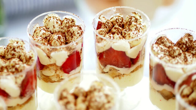 close-up, a variety of delicious desserts, cakes with cream, chocolate and strawberries. whipped cream with cinnamon. festive decor, a sweet bar, a corner, a treat. High quality photo