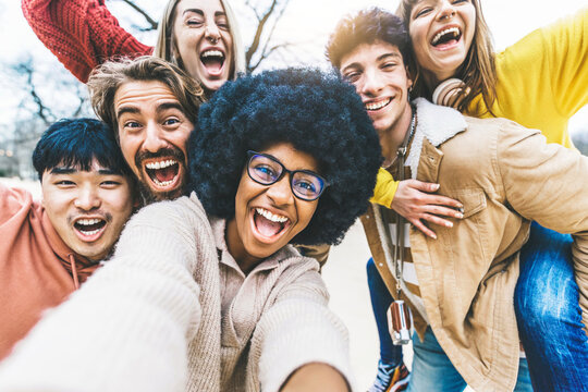Multicultural friends taking selfie picture outside - Group of young people laughing at camera together - Happy diverse students having fun in college campus - Friendship concept