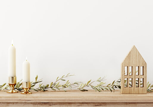 Simple and minimal Christmas interior wall mockup with candles, garland of branches and wooden decoration on rustic brown shelf on empty white background. 3d illustration, 3d rendering