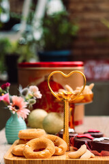 Rosquinhas com sequilhos e doces de chocolate na mesa posta com flores e bolas de natal