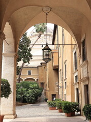 Palazzo Venezia Garden Archway with Hanging Lantern and Plants in Rome, Italy