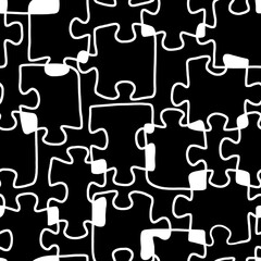 Seamless black - white background with puzzle pieces chaotically arranged. Hand-drawn. Print for fabric, packaging, cover.