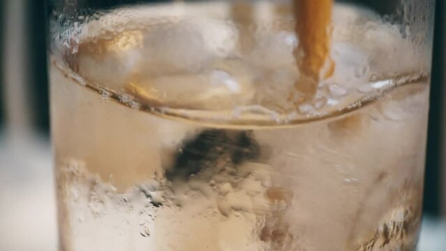Ice in a glass with a carbonated drink