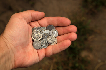 Old Roman silver coins in hand