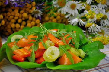 Vegetable salad with arugula on the kitchen table.
