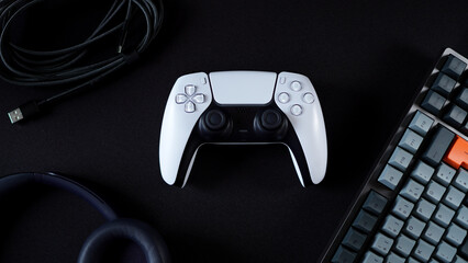 Modern gamepad surrounded by tech products