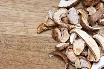 Top view of cut and dried medicinal birch polypore mushrooms on wooden cutting board, used in alternative medicine. With ample copy space.