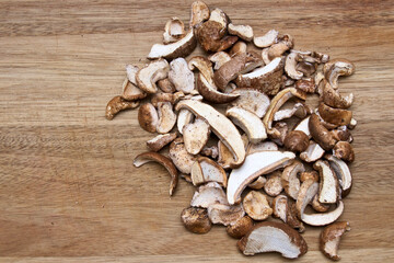 Top view of cut and dried medicinal birch polypore mushrooms on wooden cutting board, in a pile,  used in alternative medicine. With ample copy space.