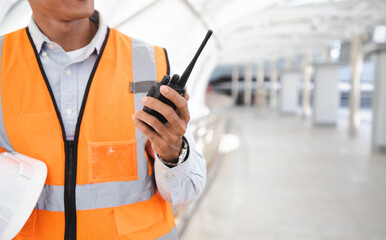 Portrait mature construction engineer confident with walkie talkie for check project and statistical report on site near cityscape. Industry concept