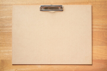 plywood clipboard on wooden desk background 
