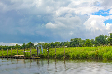 Beautiful natural landscape panorama jetty boat Oste river water Germany.