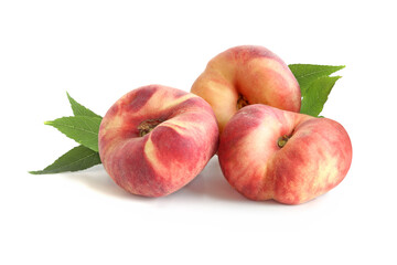 Three flat peaches with leaves isolated on white