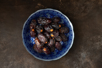 Fresh Medjool Dates in a bowl on background	