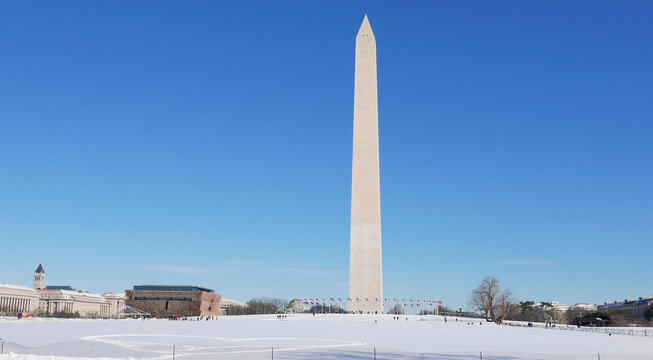 Washington Monument under snow during sunny day after blizzard event (USA, Feb. 2017). 