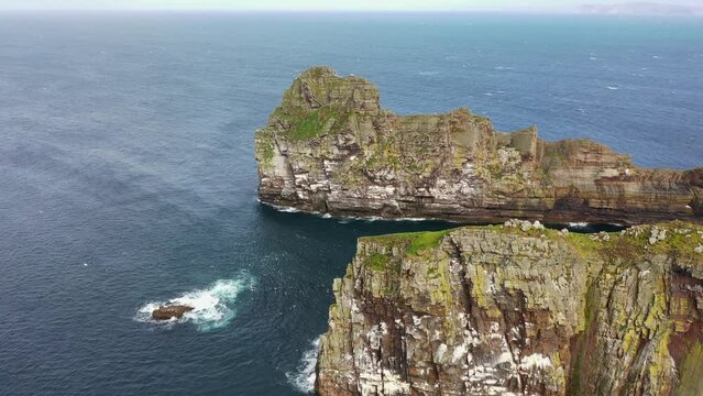 The cliffs and sea stacks An Tor Mor and the Wishing Stone at Port Challa on Tory Island, County Donegal, Ireland