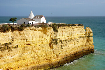 little church Senhora da Rocha with beach and cliff near Porches in the Algarve