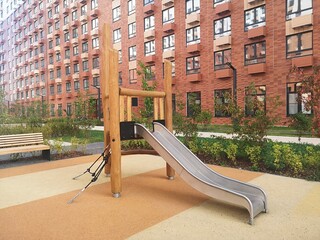 Children's playground in the park.  Wooden slide for skiing