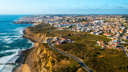 Drone aerial view over beaches, coastlines in Ericeira, Portugal, on summer sunny day. Aerial view to the Beautiful European touristic town. Beautiful cityscape with skyline, ocean rocky shore. Travel