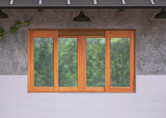 Background of glass and wooden sliding window with hanging lamps on concrete and white tile wall of vintage restaurant
