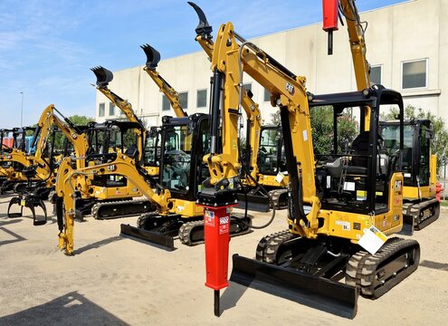 Pavia di Udine, Italy. September 3, 2022. Brand new Caterpillar mini excavators on exhibition outside the official dealer.