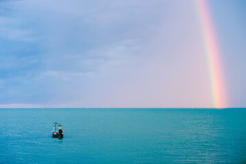 rainbow after rain in the sea
