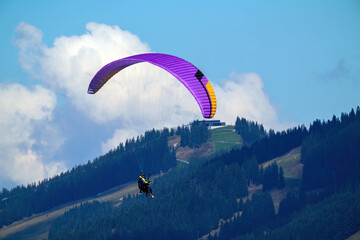 tandem paragliding at a sunny summer day in the mountains
