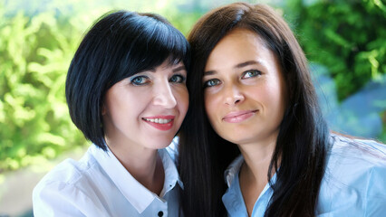 Portrait of two pleasant smiling, beautiful real 40 years old women. Happy middle aged friends...