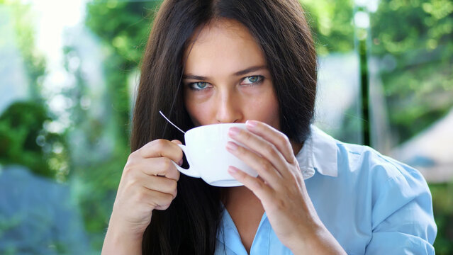 Portrait of pleasant smiling, Happy beautiful real 40 years old Ukrainian woman. a woman drinks tea without taking out a teaspoon. High quality photo