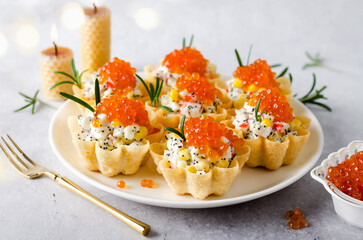 Tartlets with crab sticks, eggs, corn, poppy seeds and caviar.