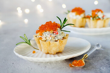 Tartlets with crab sticks, eggs, corn, poppy seeds and caviar.