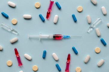 Vaccination. Syringe with medicinal substance. Tablets and capsules on the table. Medicine ampoules. The doctor prescribed treatment for the patient. Injectable drugs. Immunodeficiency.